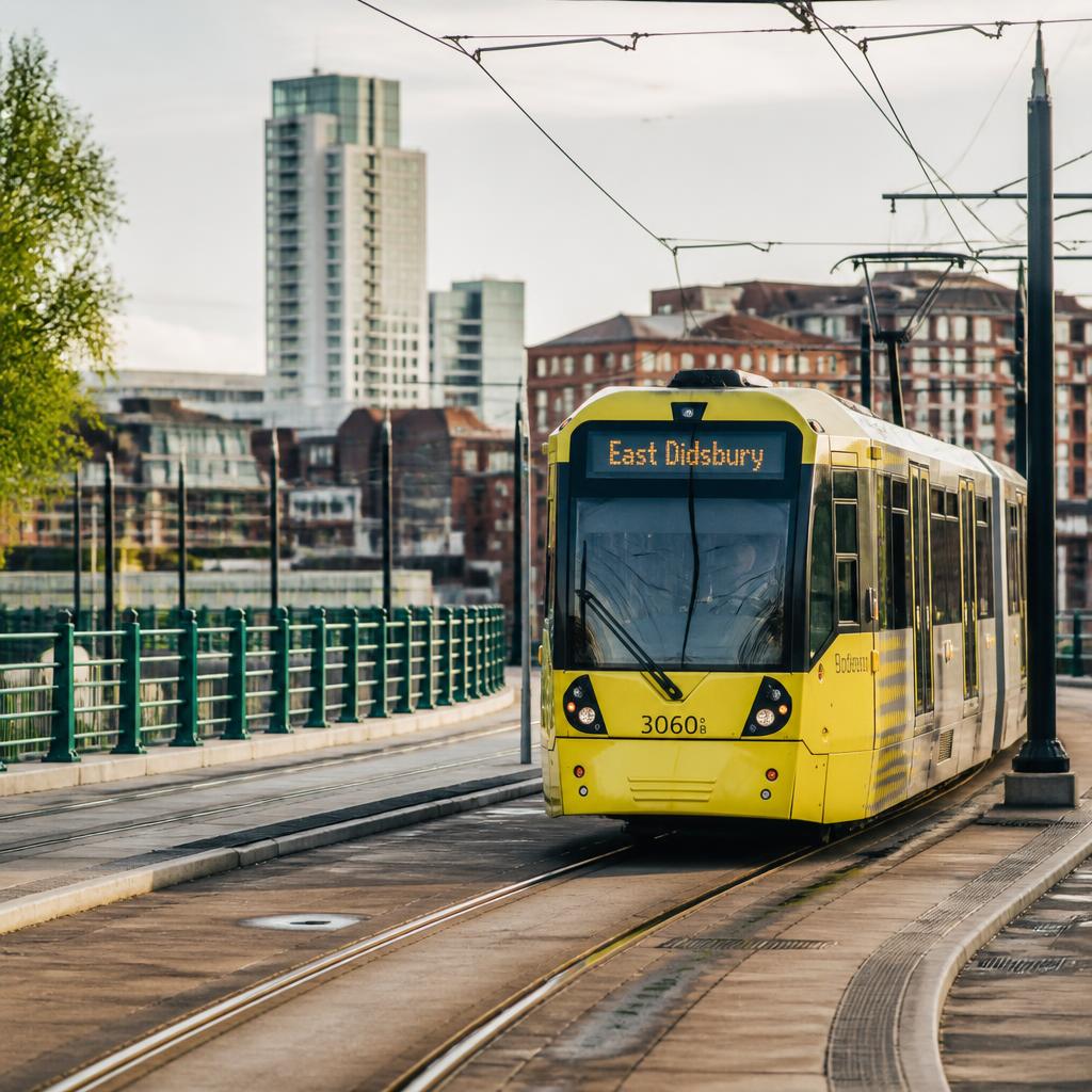 Yellow Manchester Metrolink tram with East Didsbury destination
