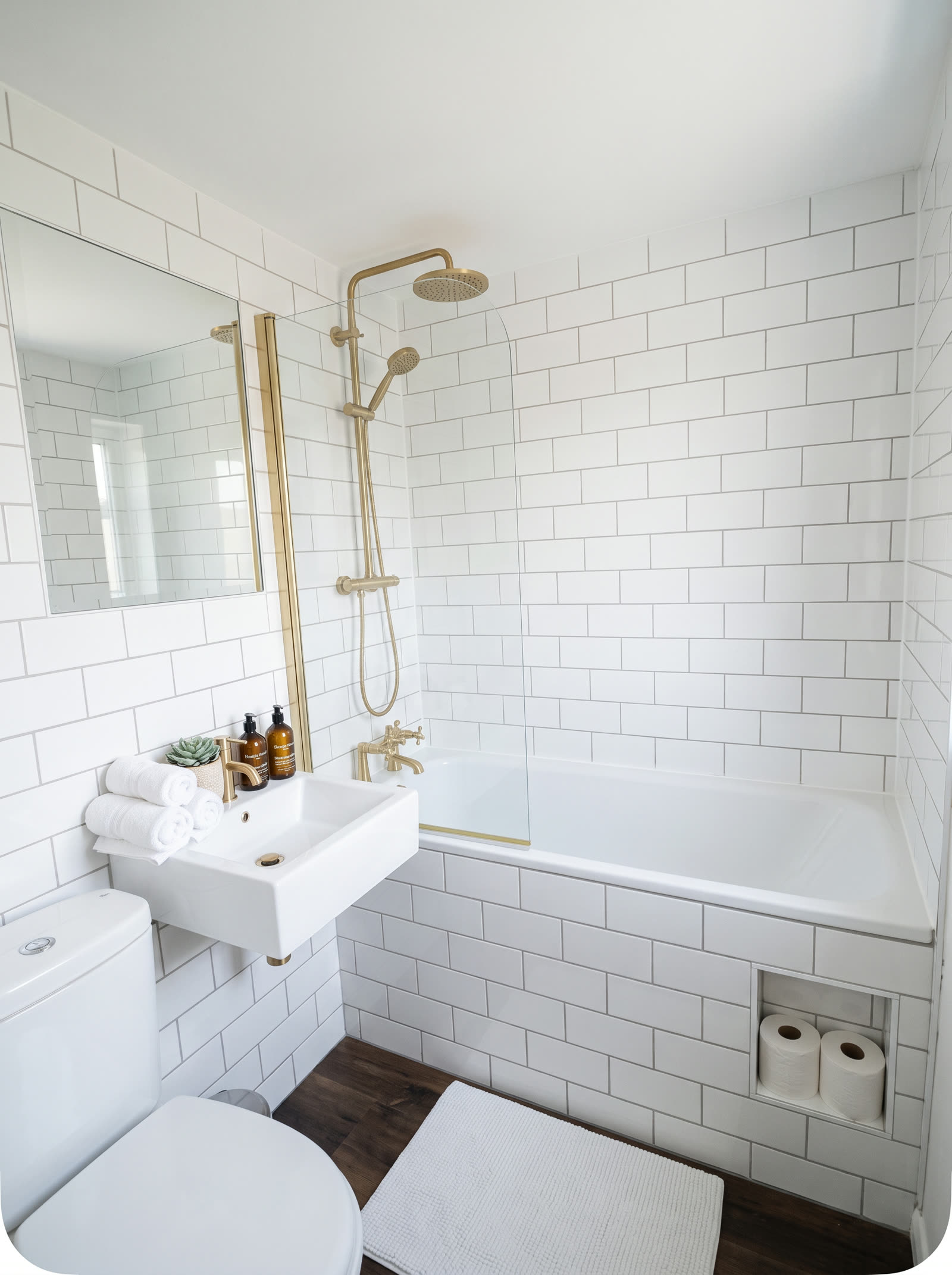 White metro tiled bathroom with bath, shower screen and basin